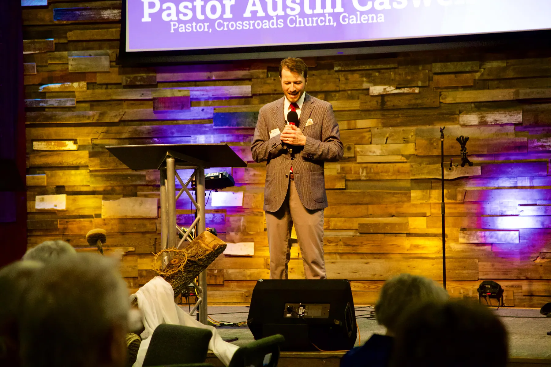 Pastor Austin Caswell of Crossroads Church speaking on stage