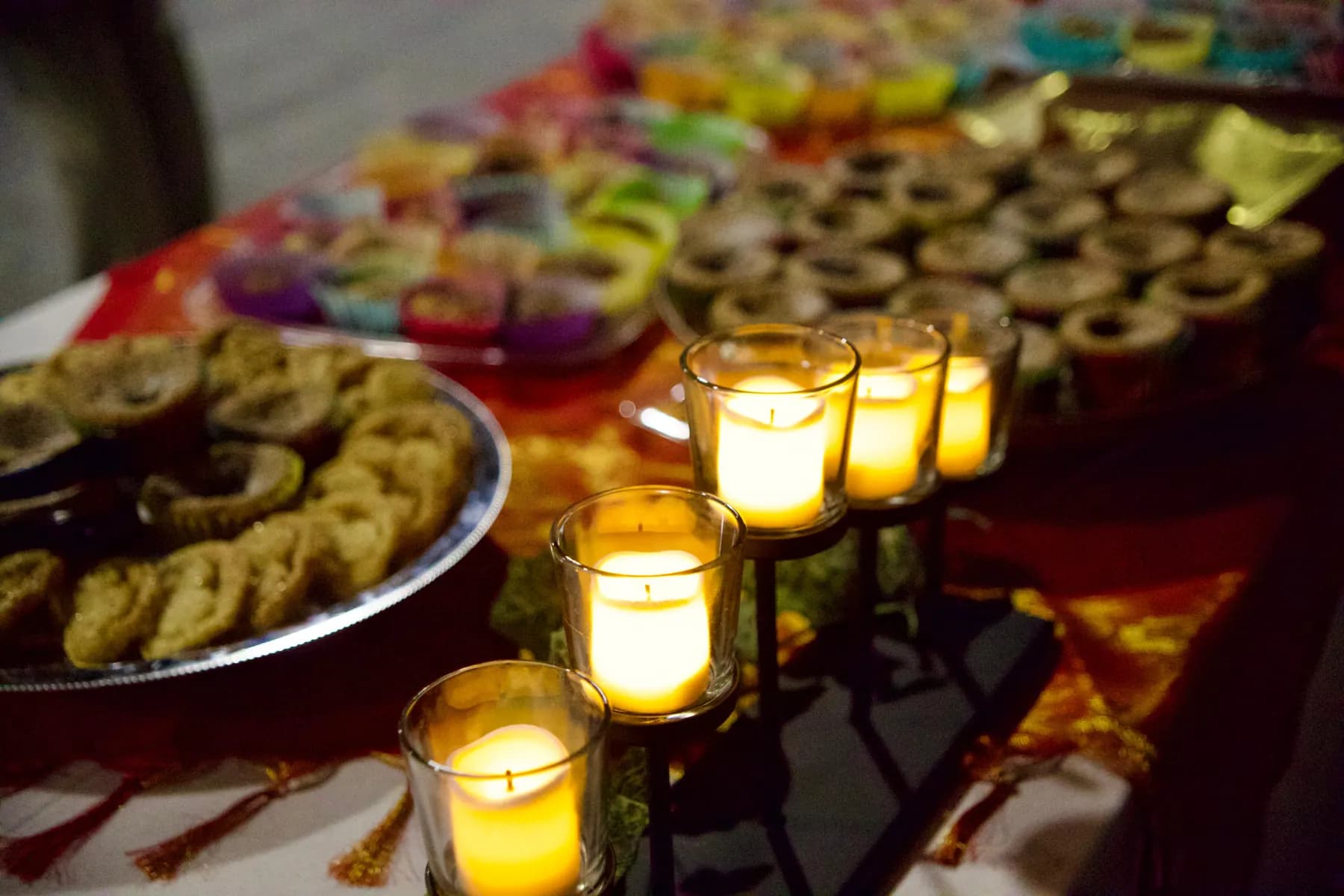 Warm candlelight on the dessert table