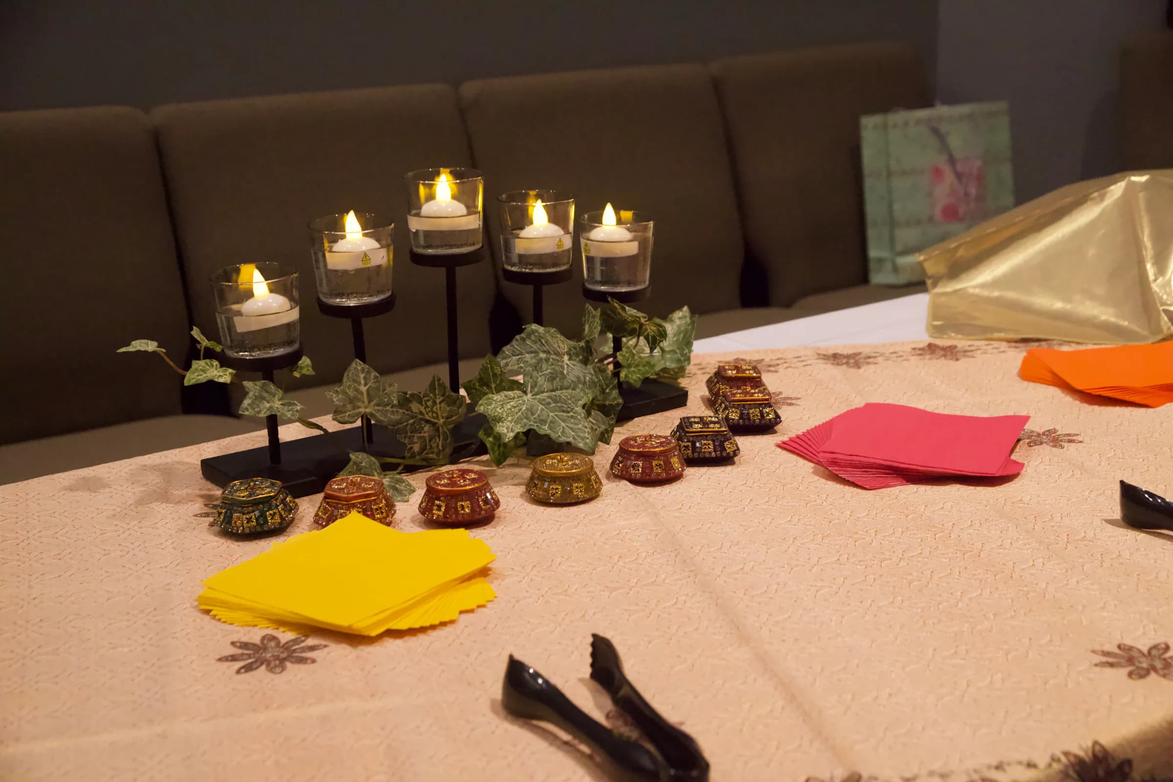 Candles and brass bowls arranged on a table
