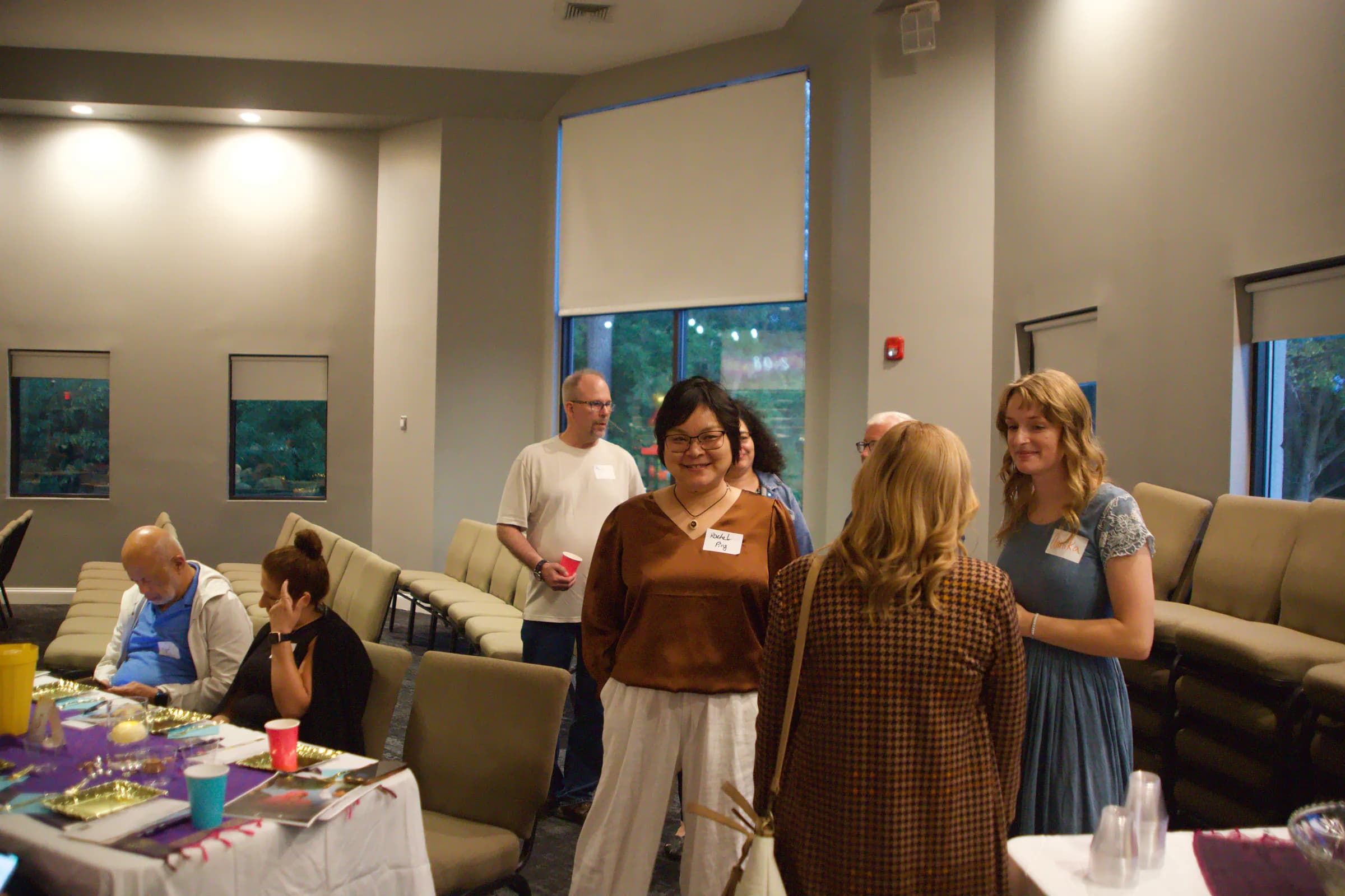 Guests talking together before the program