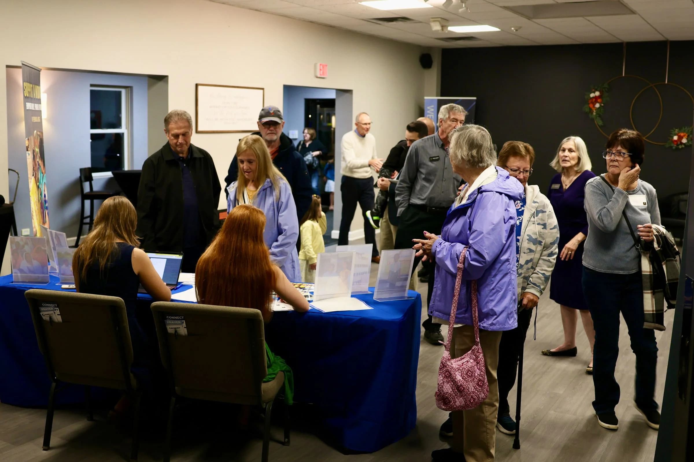 Guests arriving at the welcome table