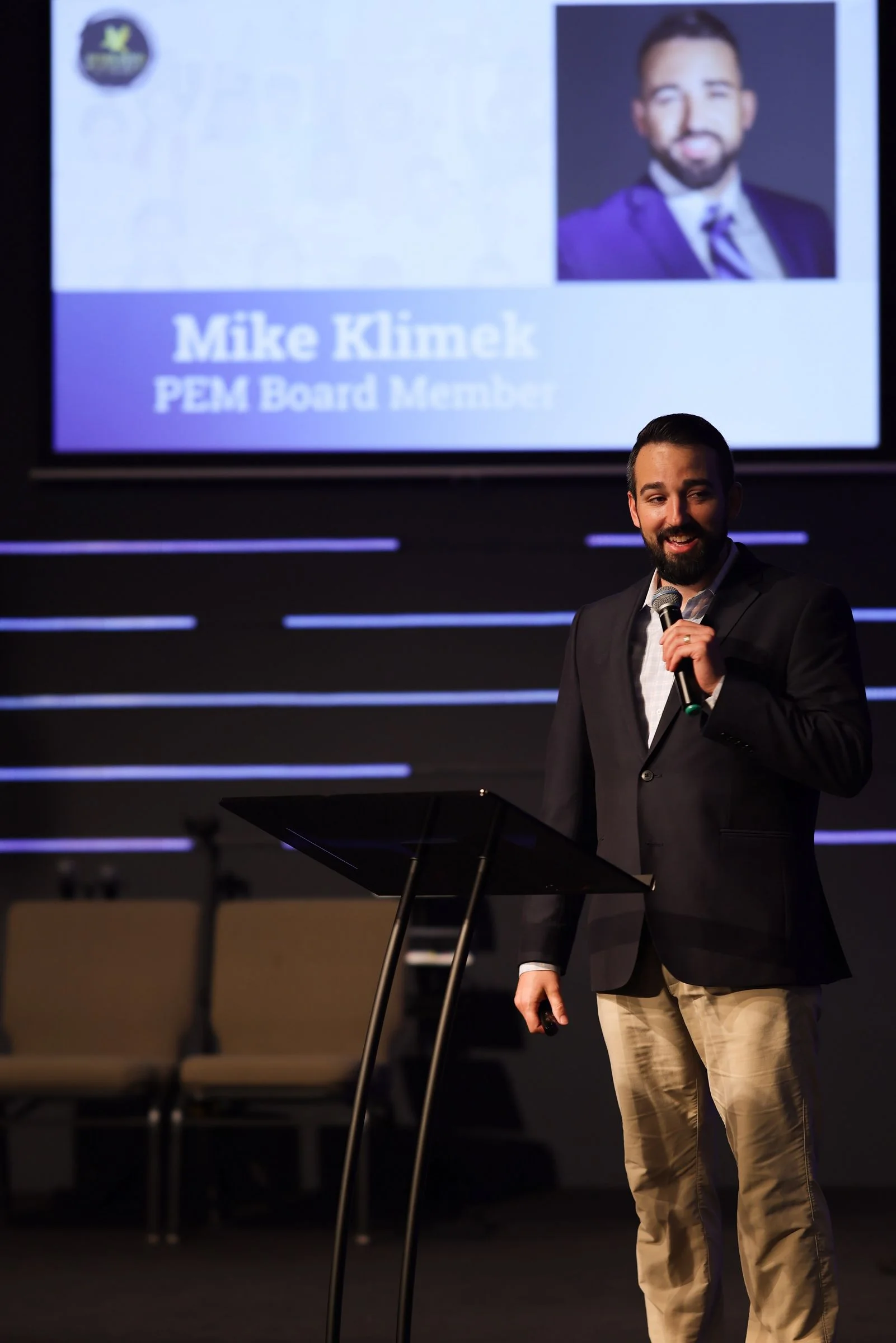 A board member speaking on stage