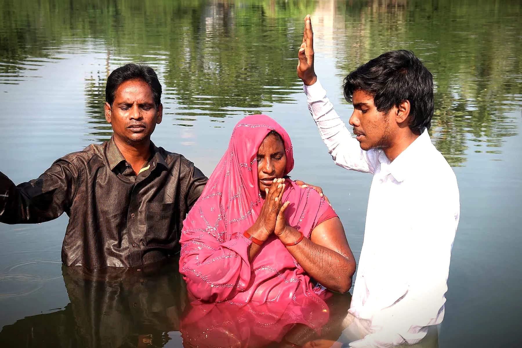 A woman being baptised in a river