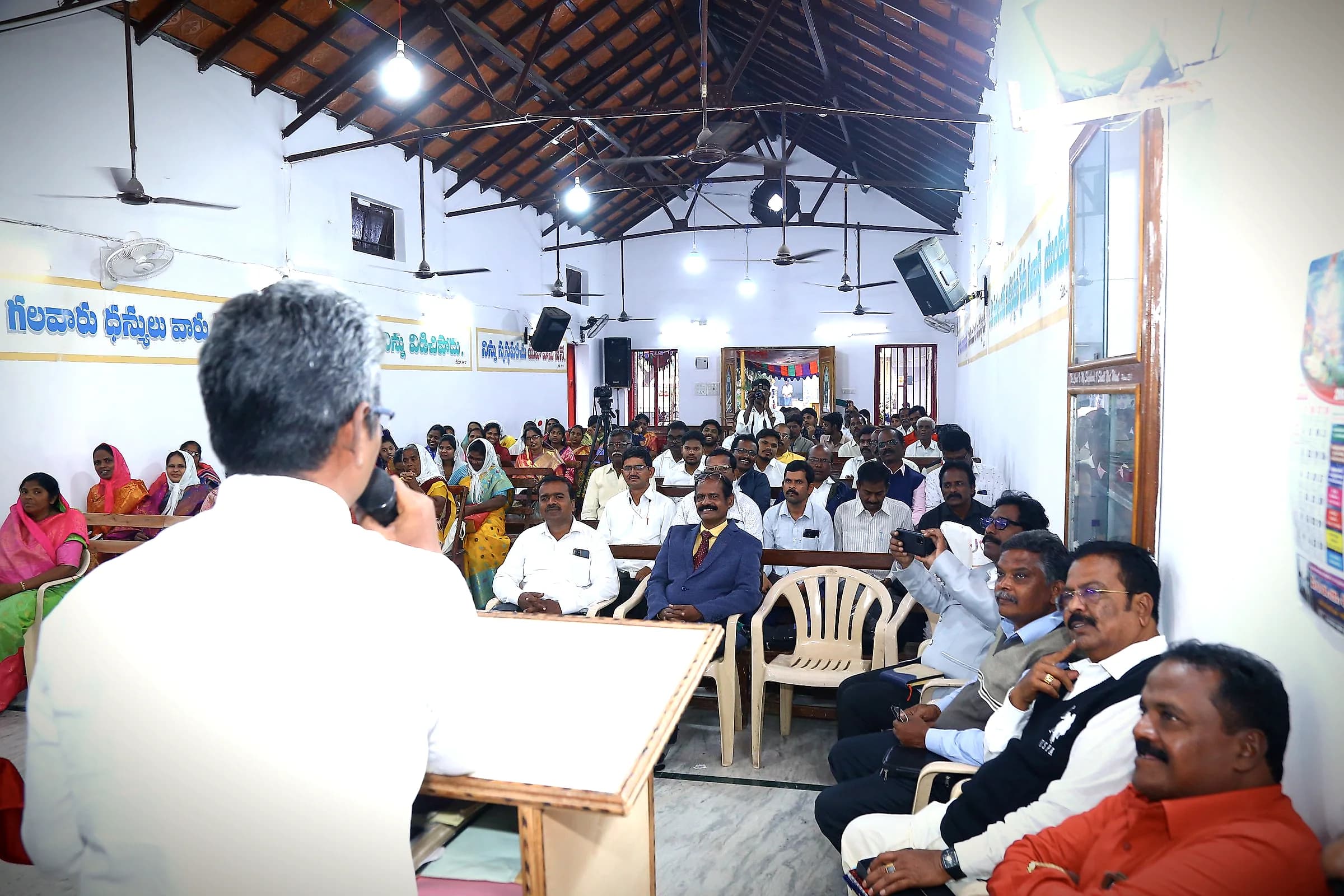 A speaker addressing a hall full of pastors