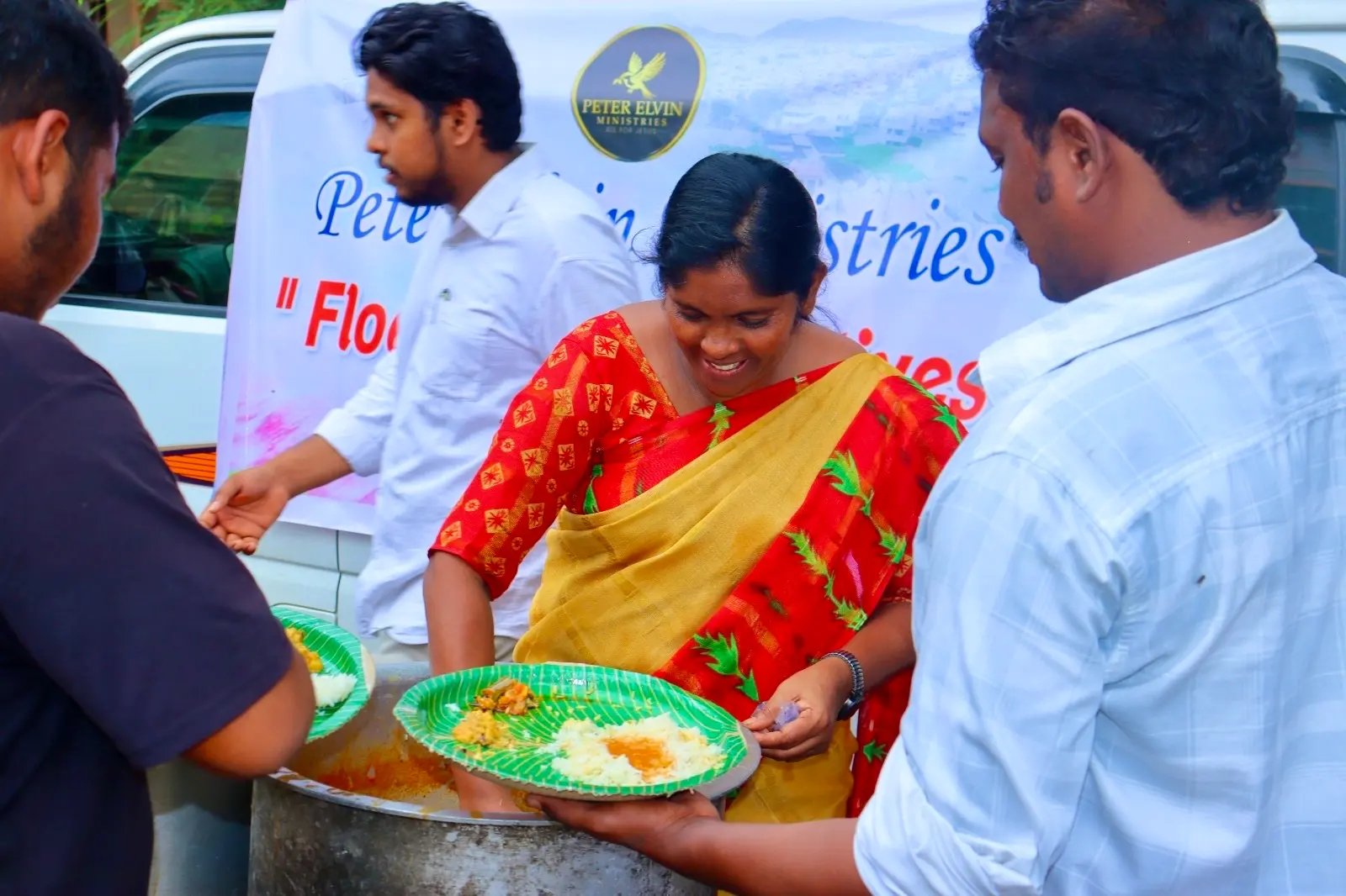Volunteers serving hot meals during flood relief in India