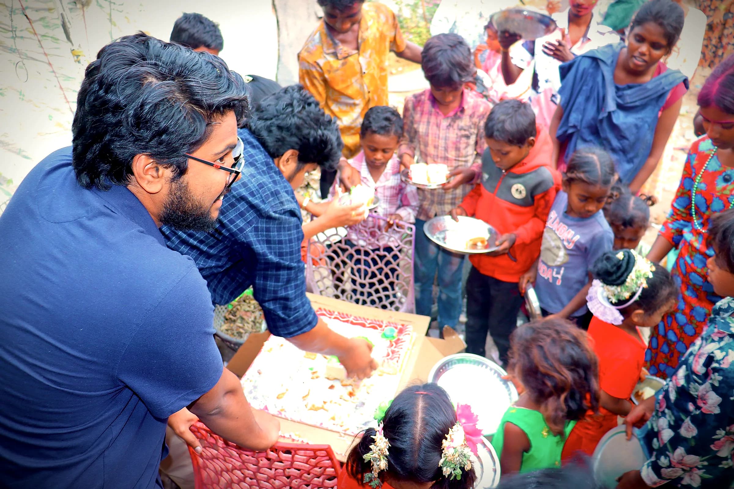 Ministry volunteers serving food to a crowd of children