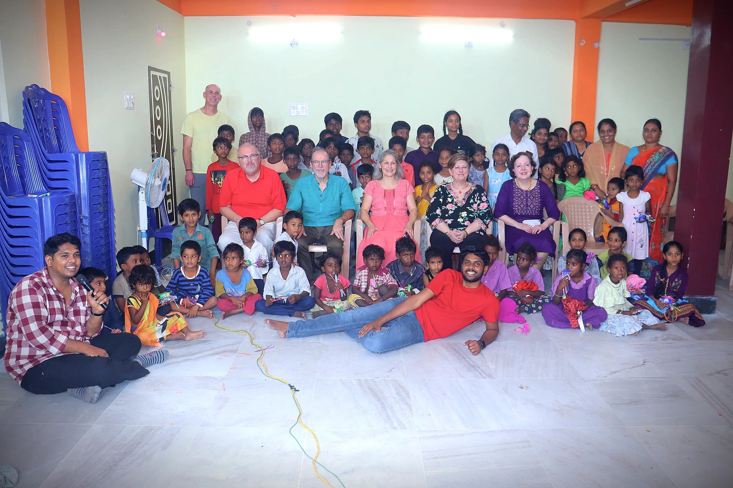 Children and visiting team members gathered for a group photo